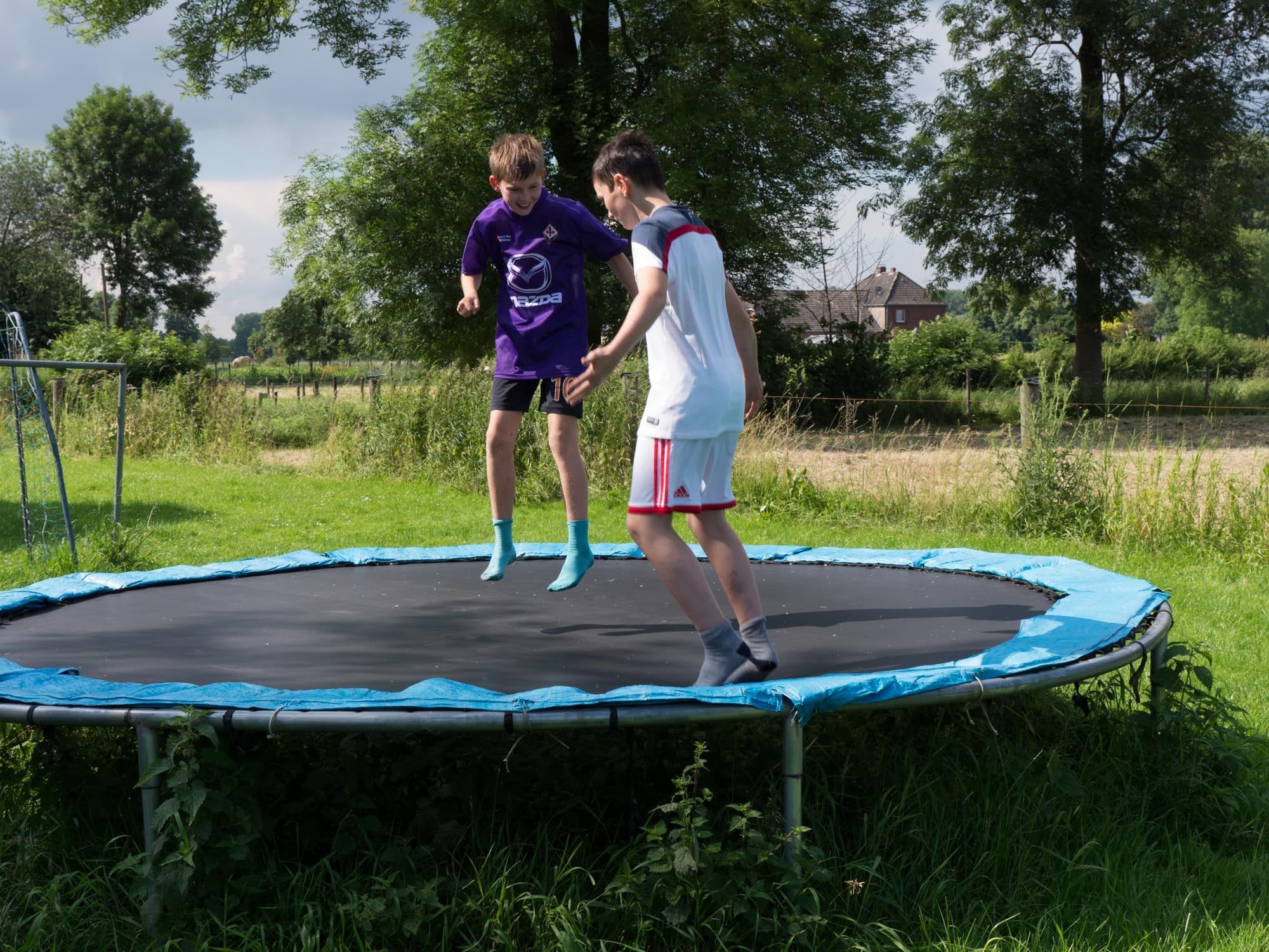 Zwei Kinder springen auf dem Trampolin